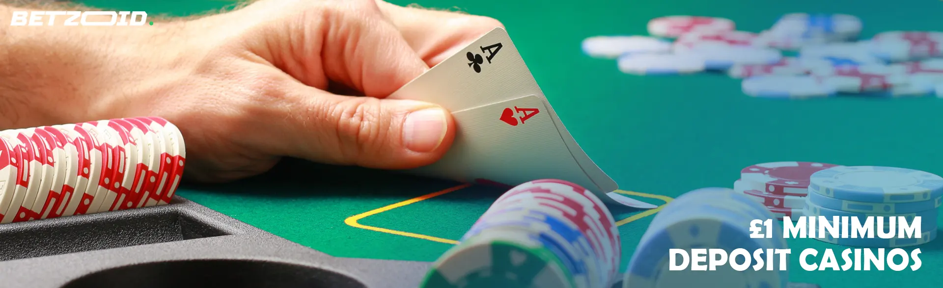 The player holds the cards next to the casino chips.