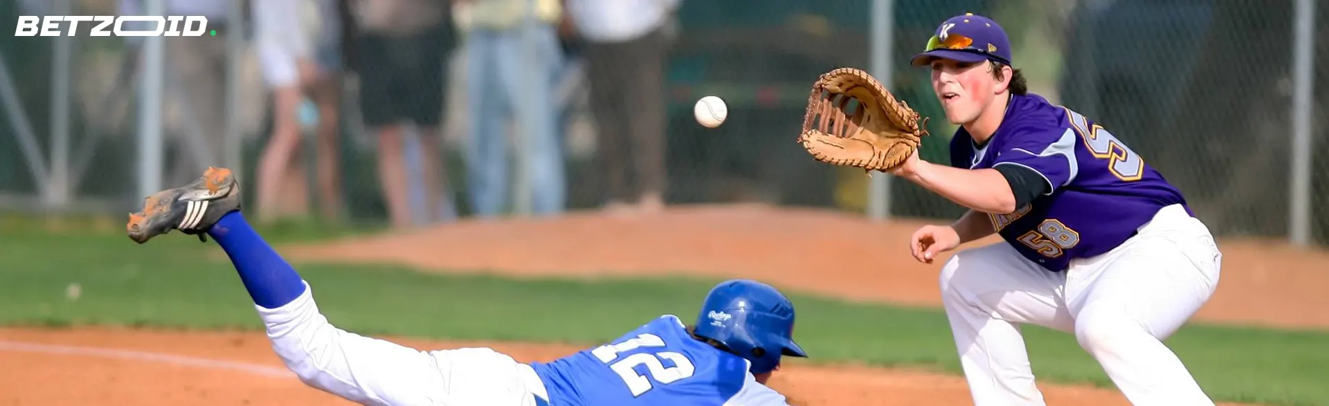 A baseball player is trying to catch the ball.