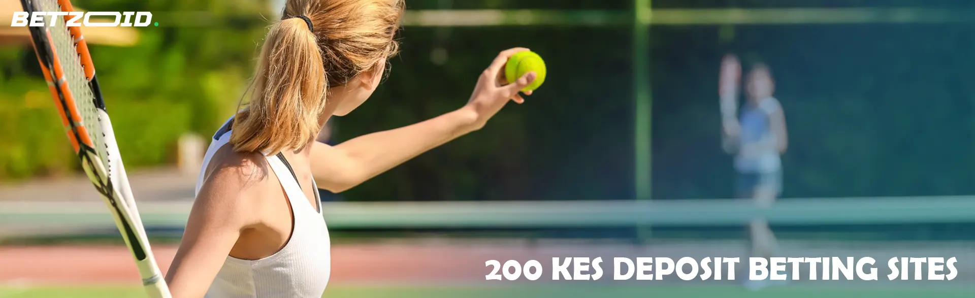 A tennis player prepares to serve on the court.