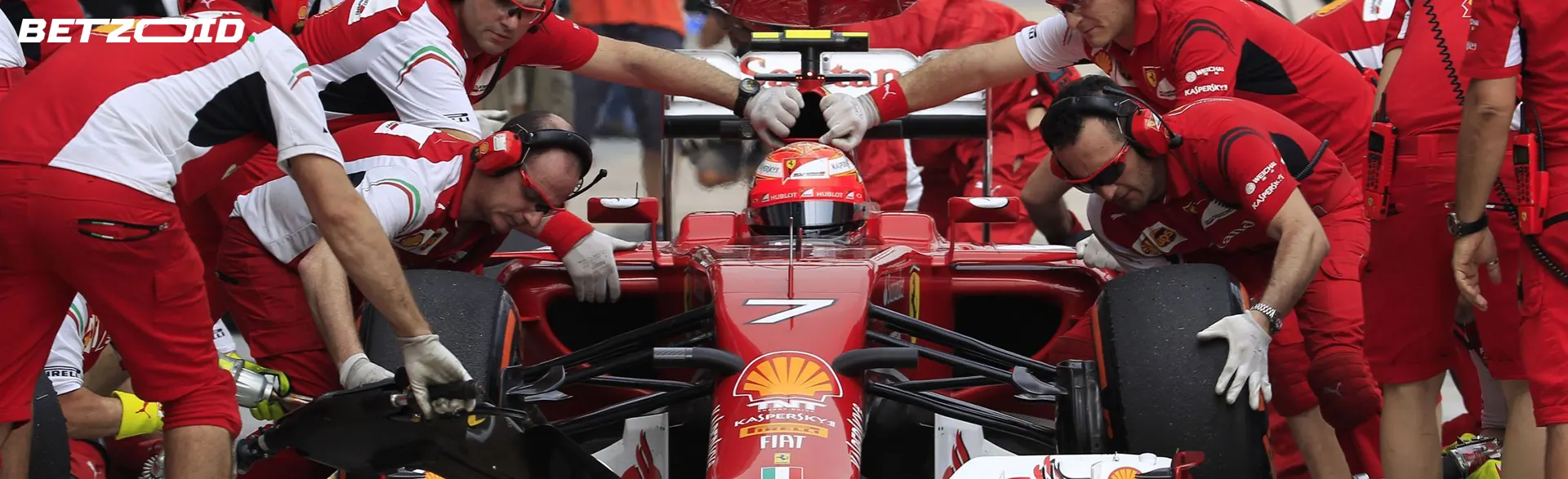 A team of mechanics conducts a pit stop for a racing car.