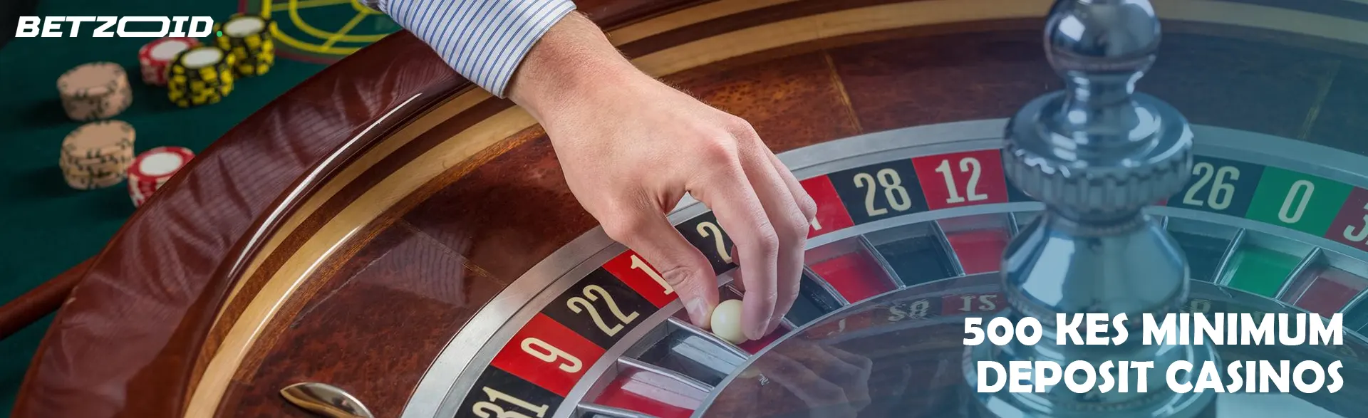 A hand puts a ball on a casino roulette wheel.