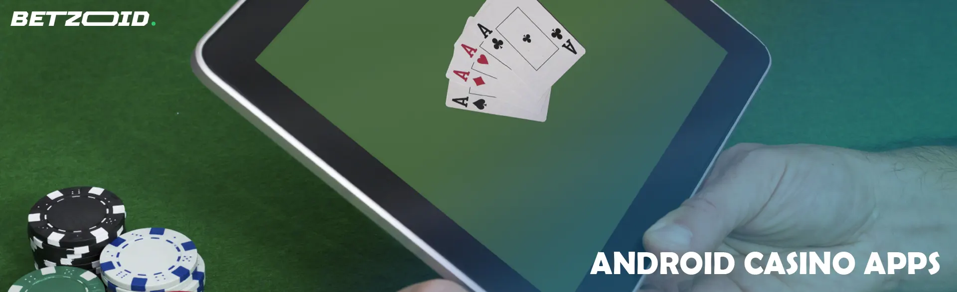 A man holds a tablet next to casino chips.
