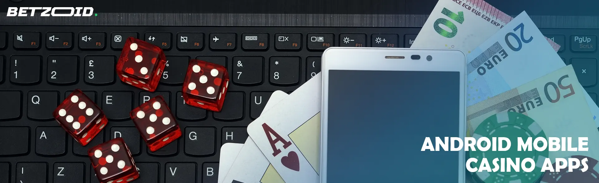 Smartphone, dice, money and chips lie on the keyboard.