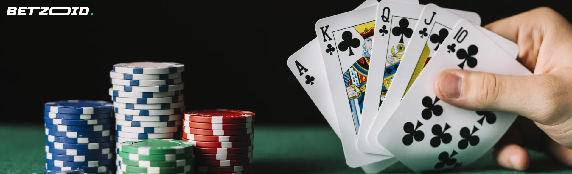 The player holds the cards next to the casino chips.