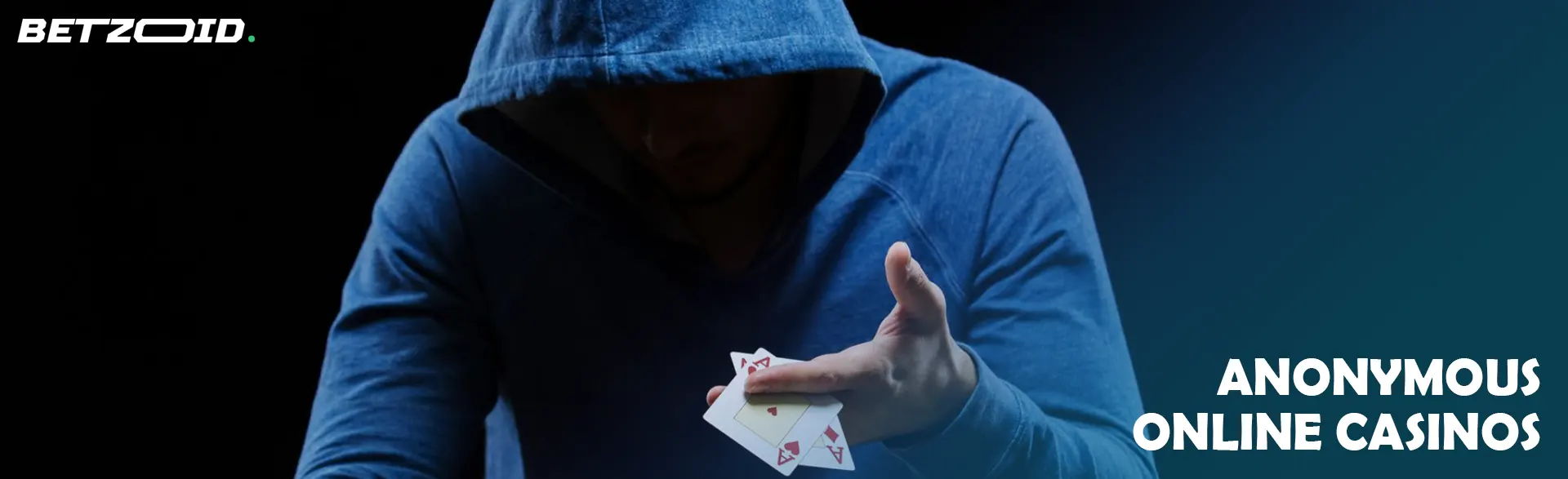 A man in a hood shows playing cards.