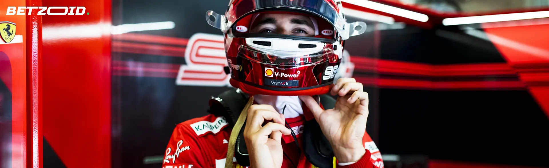 A racer puts on a helmet before a race.