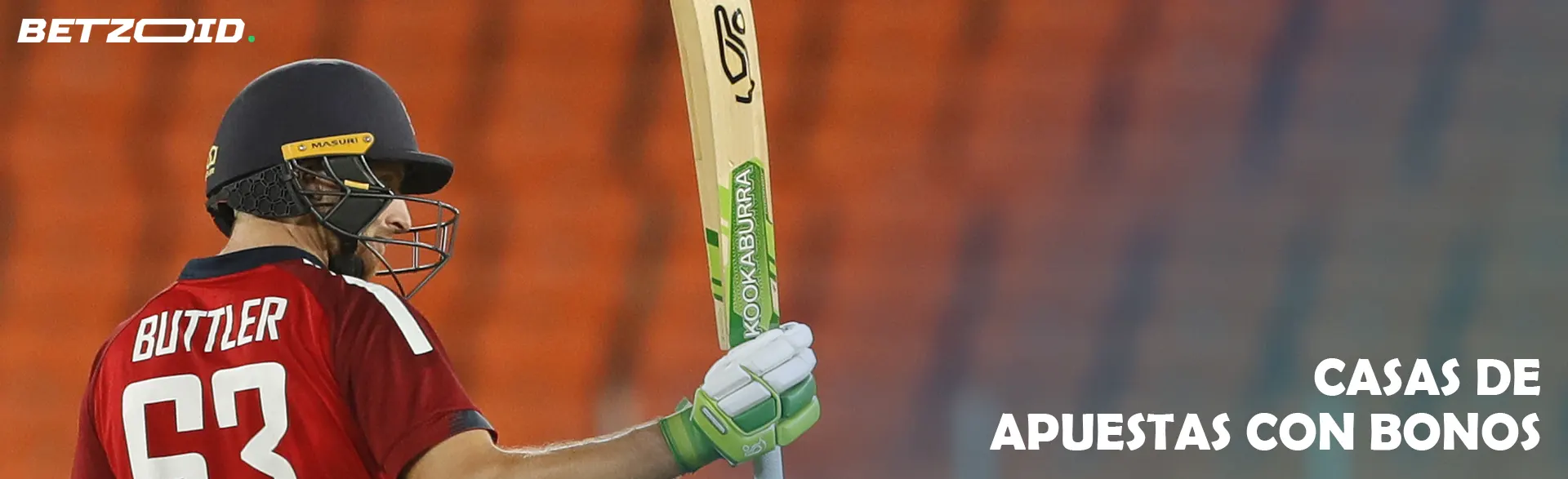 Un jugador de críquet con un bate delante de las gradas.