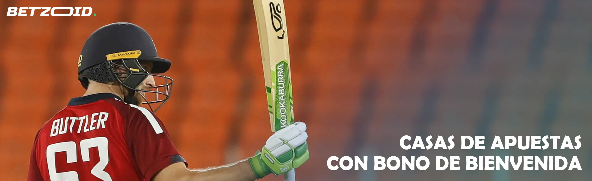 Un jugador de críquet con un bate delante de las gradas.