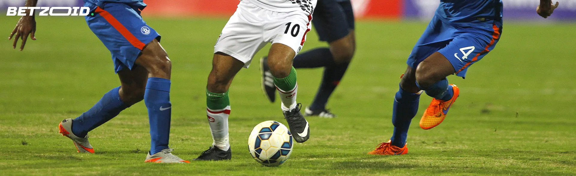Football players fight for the ball during the match.