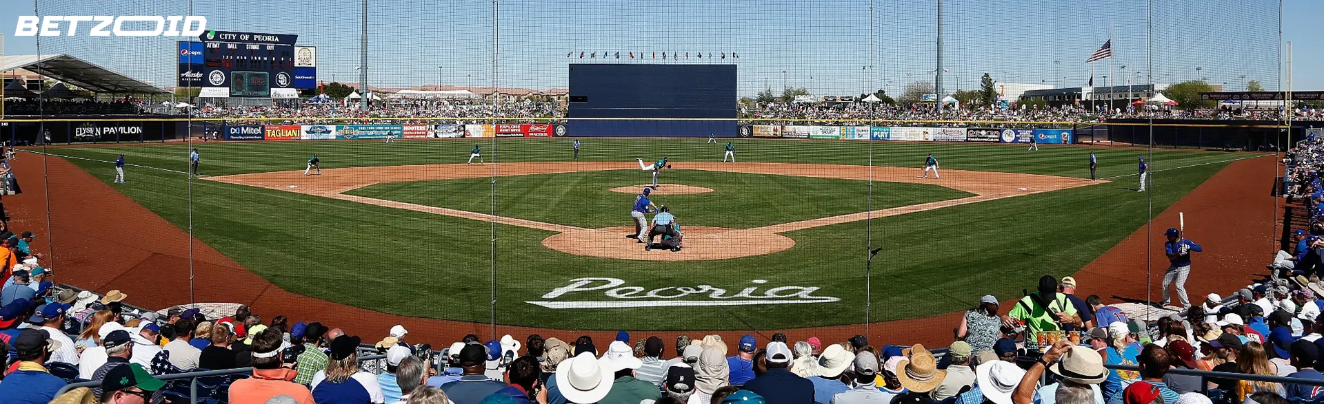 Baseball match with stands of fans.