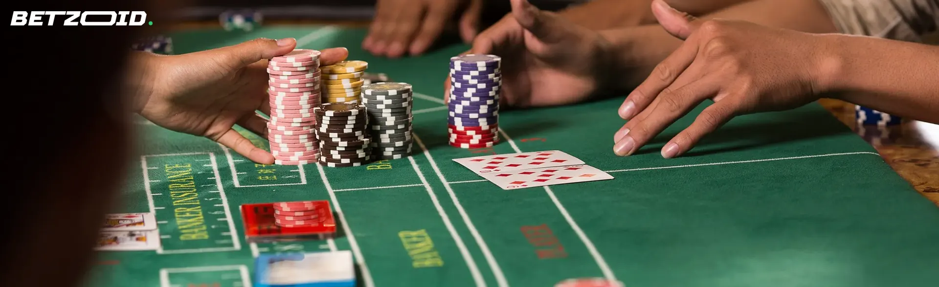 Players place bets with chips on the casino table.