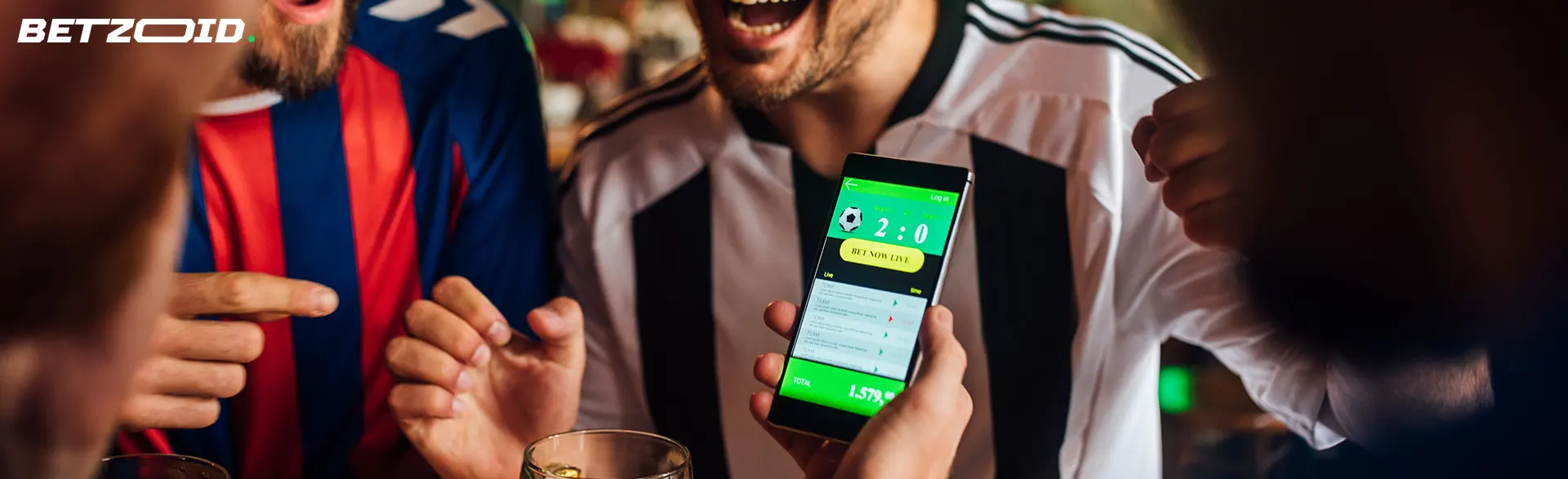 Betting app on smartphone in human hand.