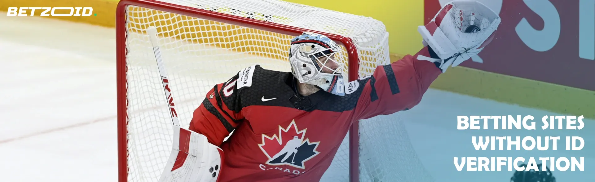 A hockey goalie catches the puck near the goal.
