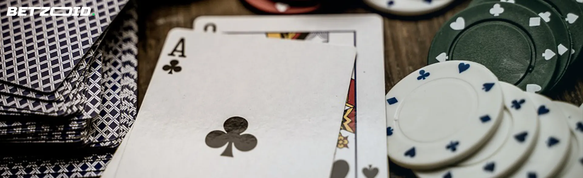 A poker table with an Ace of clubs and poker chips.