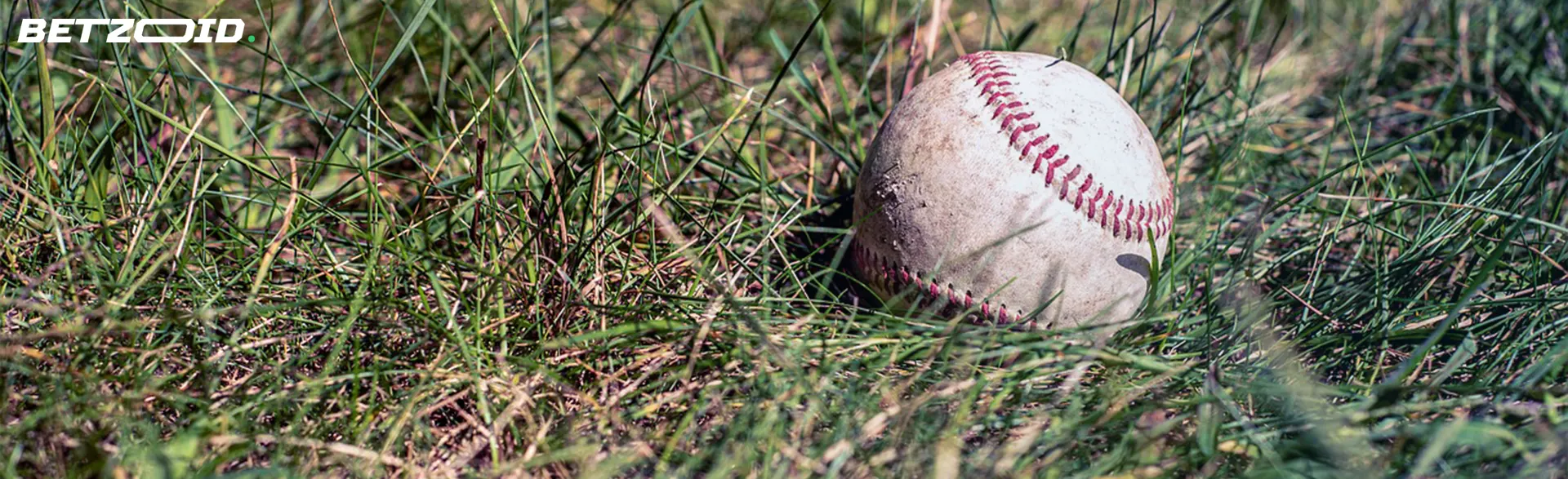 Baseball on grass field suggesting strategies for Kenyan betting sites with sign-up bonuses.