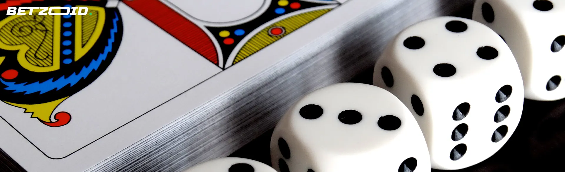 Dice next to a deck of cards.