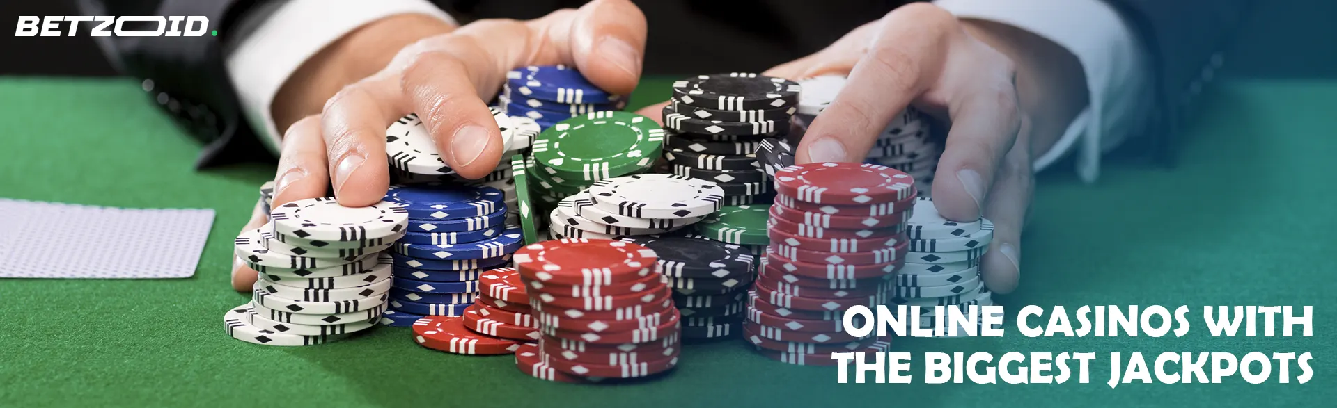 A player is holding a pile of chips on a casino table.