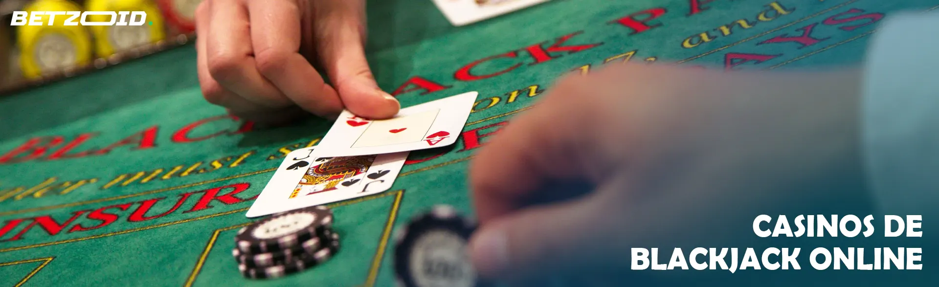 Mano del jugador de blackjack sosteniendo cartas en la mesa verde.