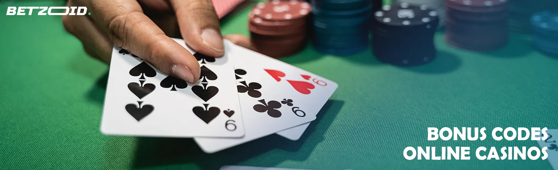 The player holds the cards next to the casino chips.