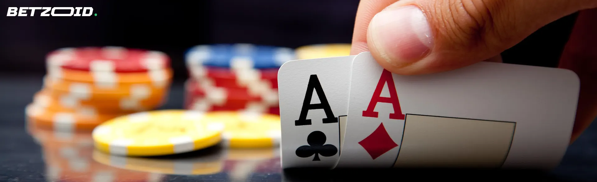 The player holds cards on the background of casino chips.