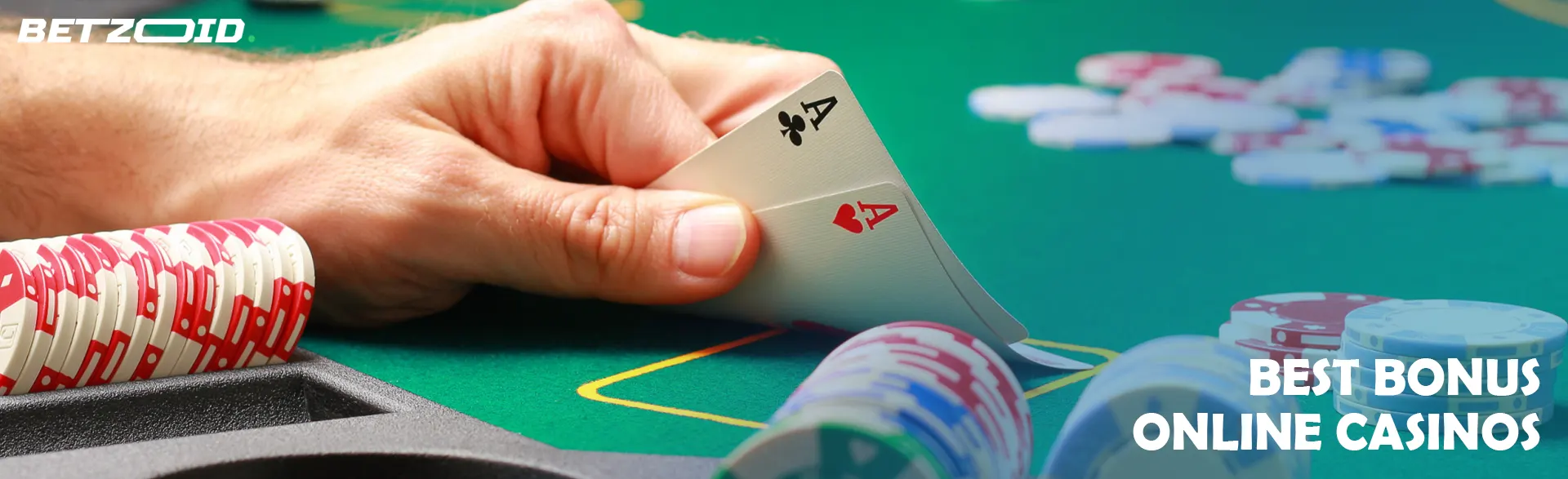 The player holds the cards next to the casino chips.