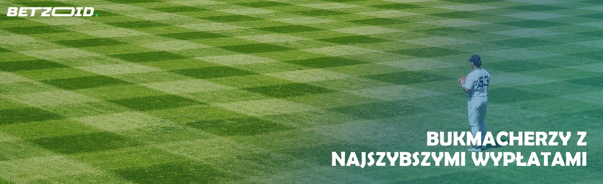 Gracz baseballu stoi na pustym polu.