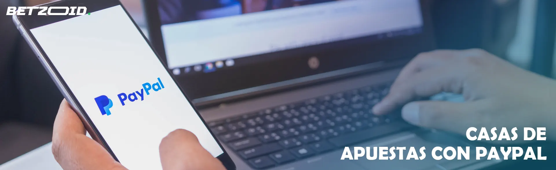 Una persona sostiene un teléfono inteligente con el logotipo de PayPal en la pantalla.