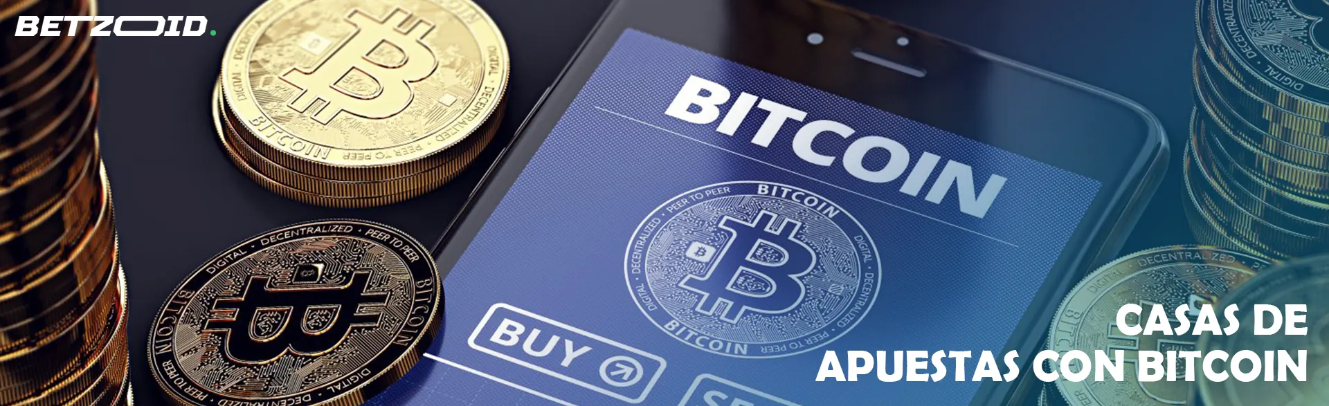 Monedas Bitcoin junto a un dispositivo móvil.