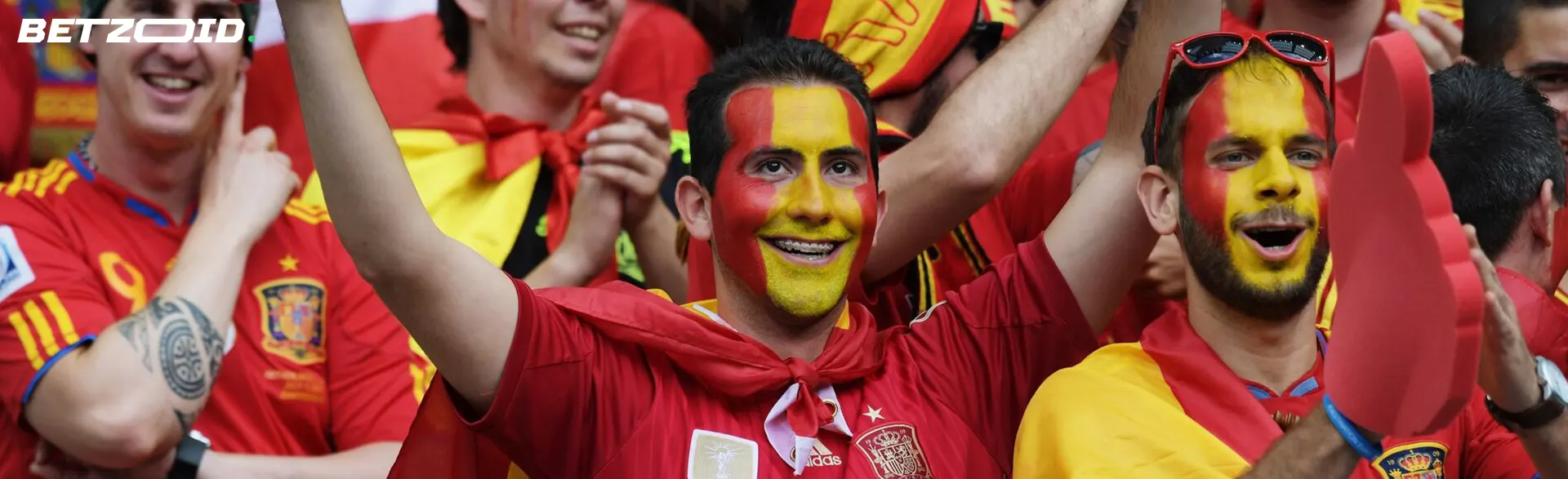 Aficionados españoles celebrando en un evento deportivo en casas de apuestas con apuesta gratis.