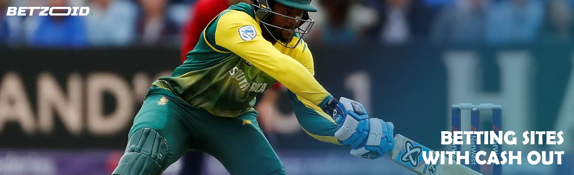 A cricketer tries to hit the ball.