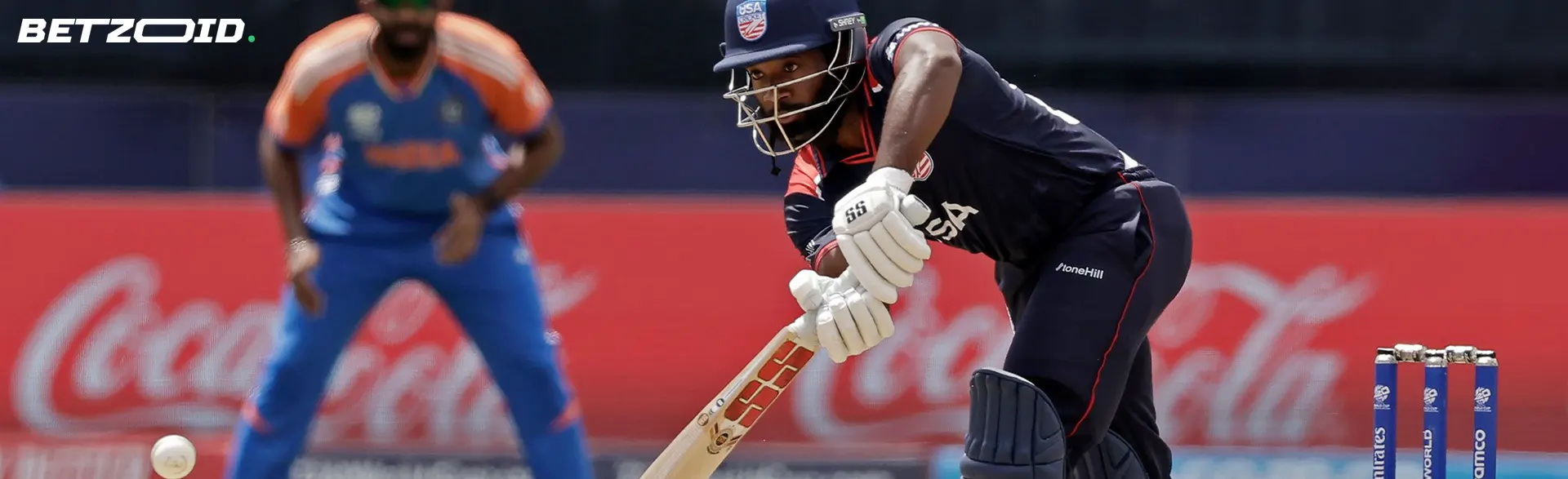 A cricketer tries to hit the ball.