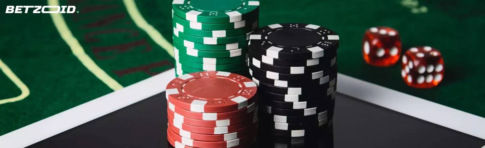 Dados y fichas de póquer sobre una mesa verde.