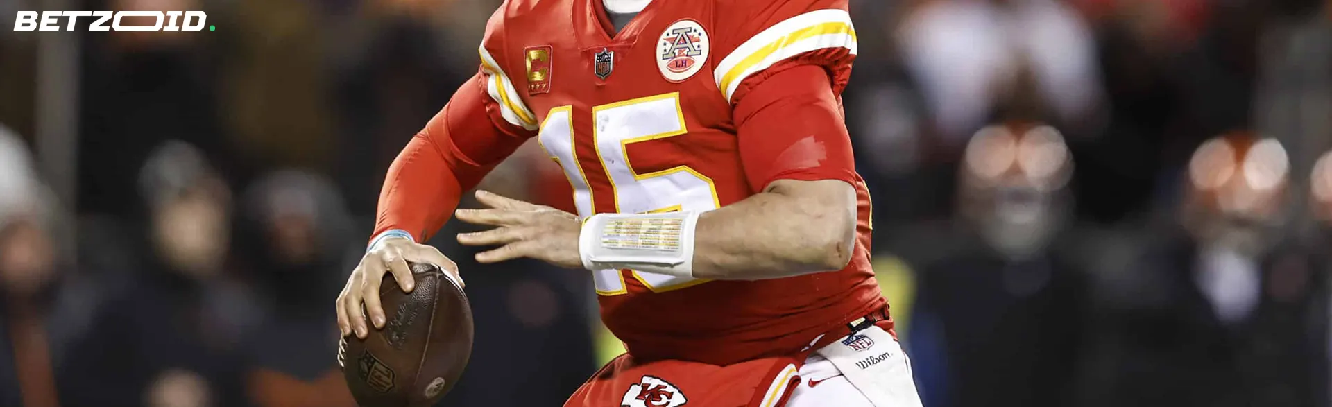 A football player in action, wearing a red jersey with the number 15, highlighting the best football betting websites in Canada for enthusiasts and bettors.