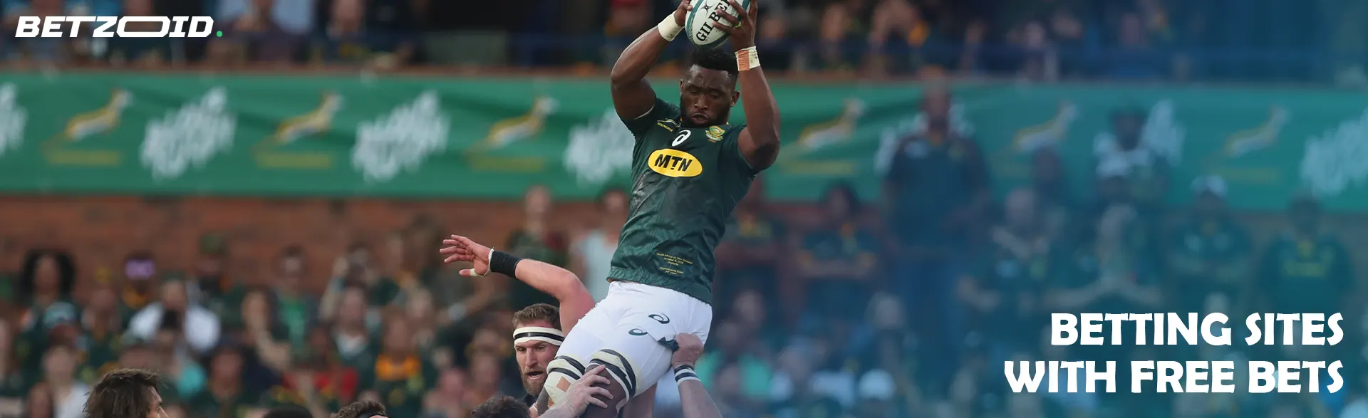 A rugby player catches the ball in a jump.