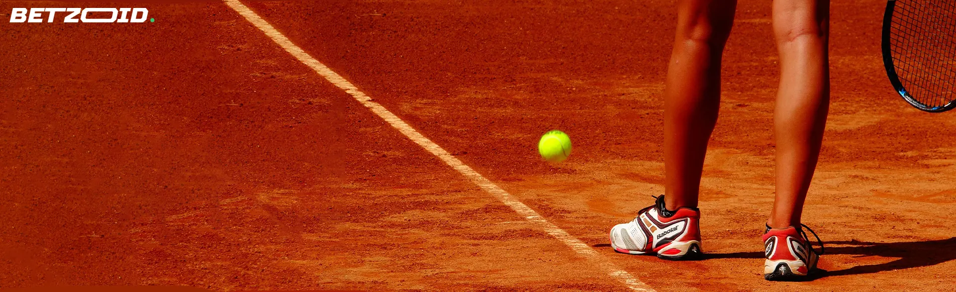 Tennis player's feet on a clay court with a bouncing ball, highlighting dynamic sports events covered by free matched betting sites Canada.