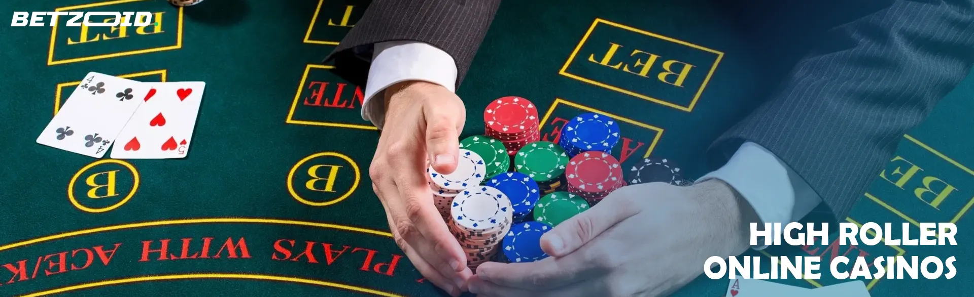 A player holds a pile of chips on the casino table.
