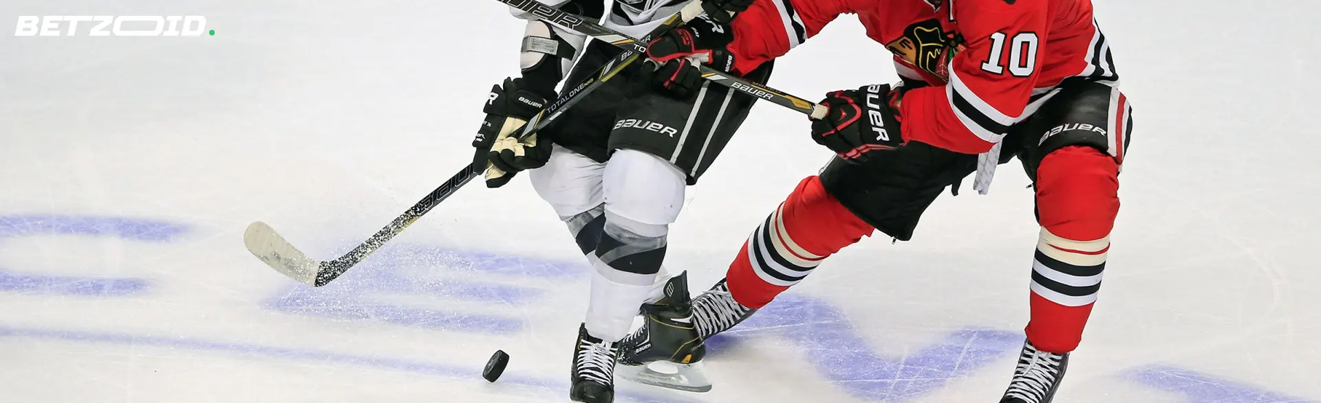 Hockey players fight for the puck during the match.