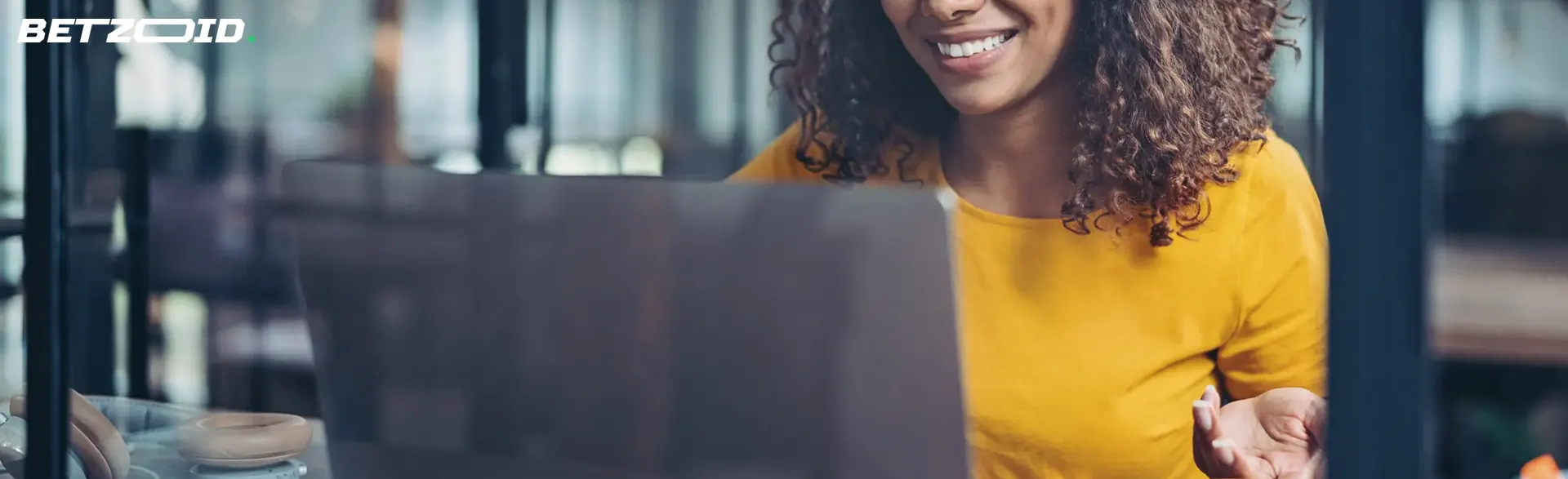 A woman in front of a laptop screen.