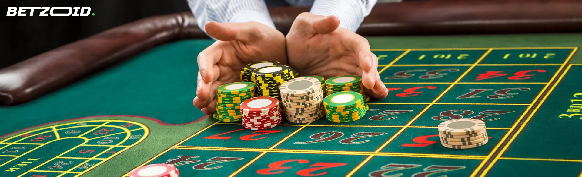 A player is holding a pile of chips on a casino table.
