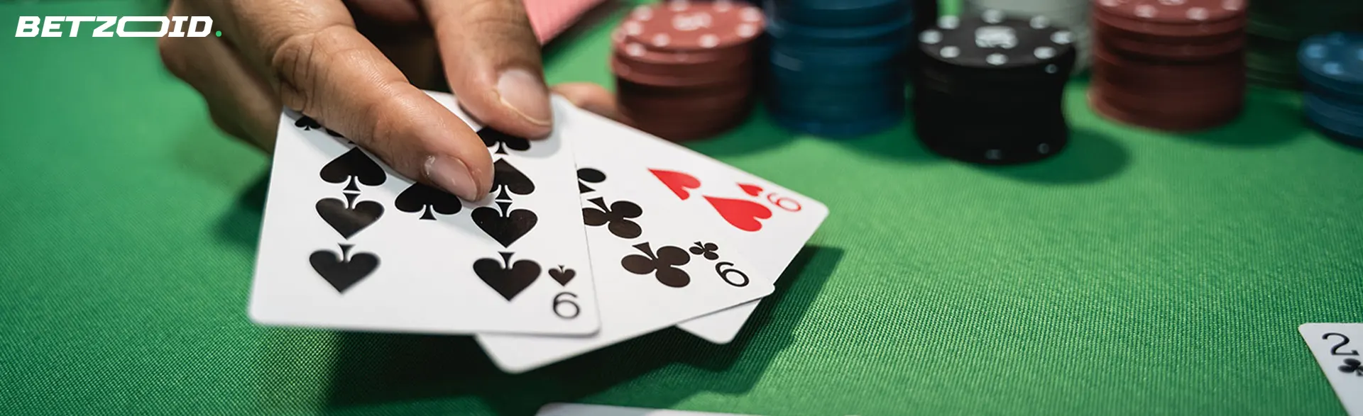 The cards are in the hands of the player next to the casino chips.