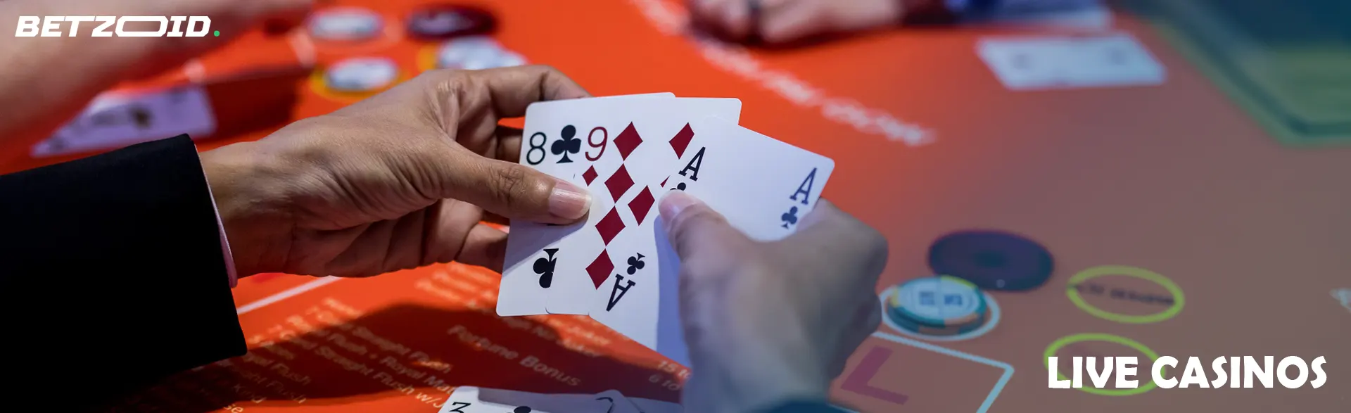 A player holds cards during a casino game.