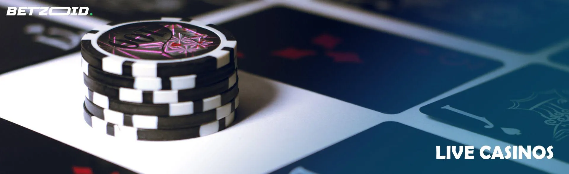 Stack of casino chips next to black cards.