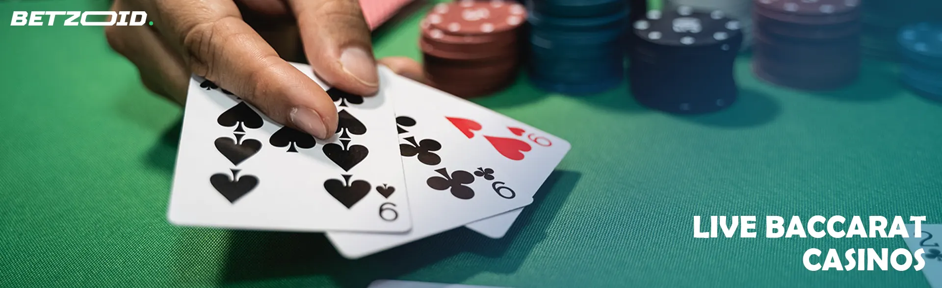 The player holds the cards next to the casino chips.