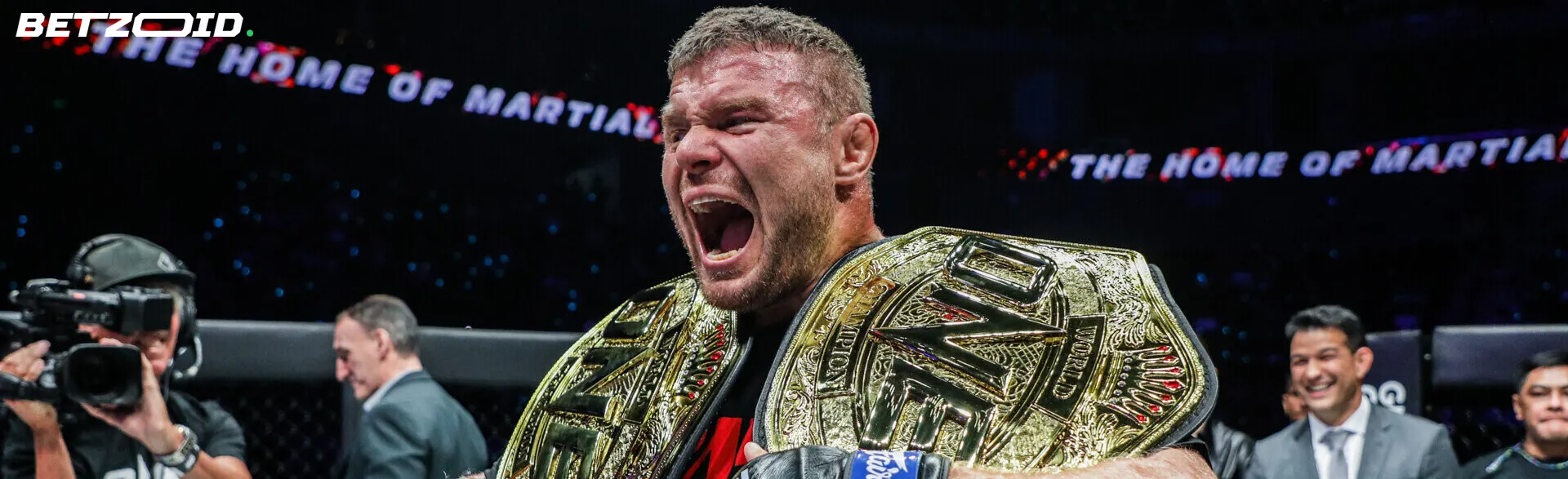 A victorious fighter holding a championship belt at a live event, symbolizing the thrill and action featured on live betting sites in Canada.