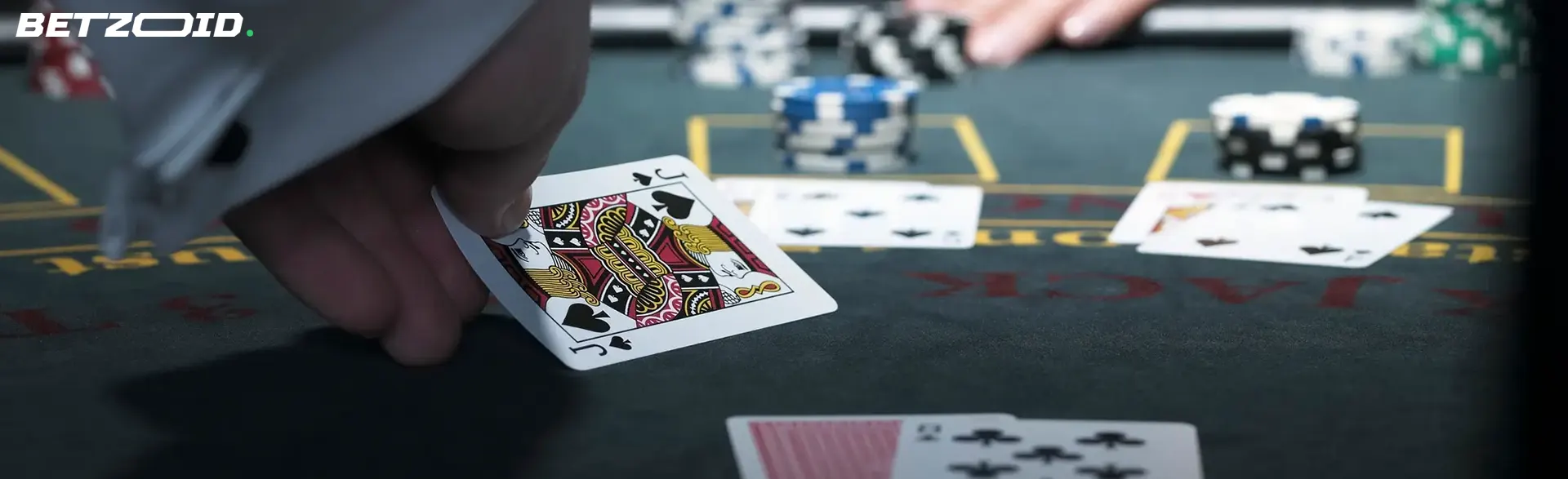 A close-up of a blackjack table with a player holding a jack of spades, emphasizing the excitement of live blackjack casinos in Canada.