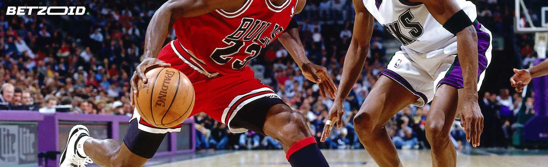 Two basketball players compete for the ball.