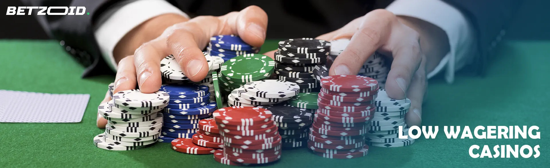 A player is holding a pile of chips on a casino table.