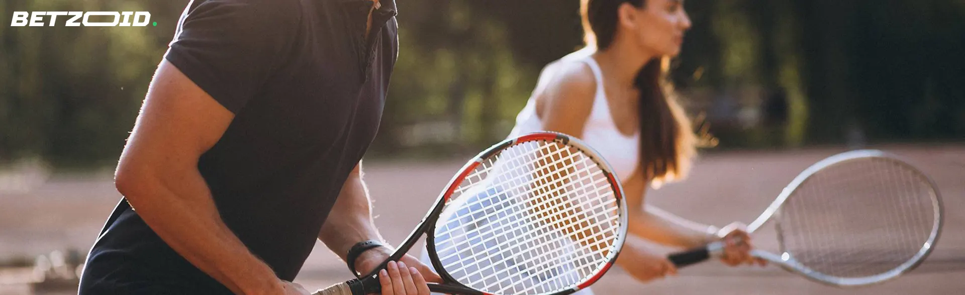 Tennis players prepare to hit.