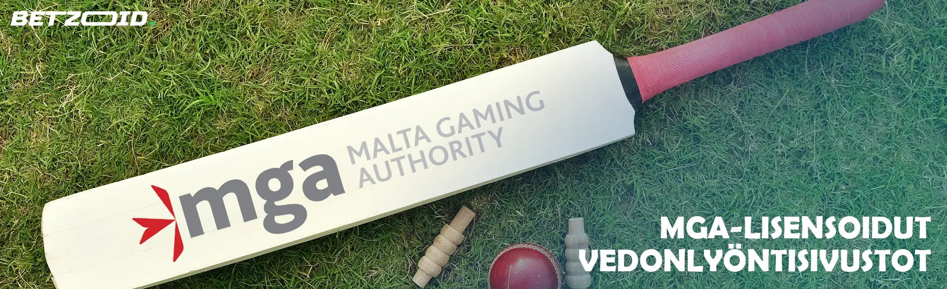 Krikettimaila, jossa Mga-logo krikettipallojen vieressä.