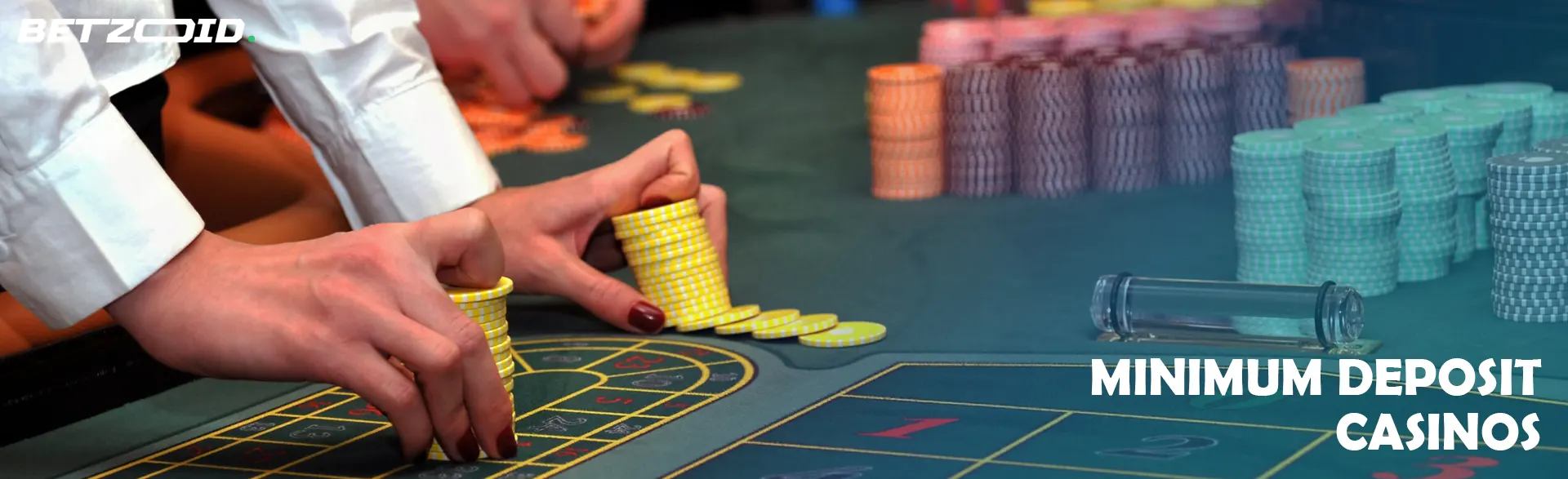 A player holds chips on the casino table.